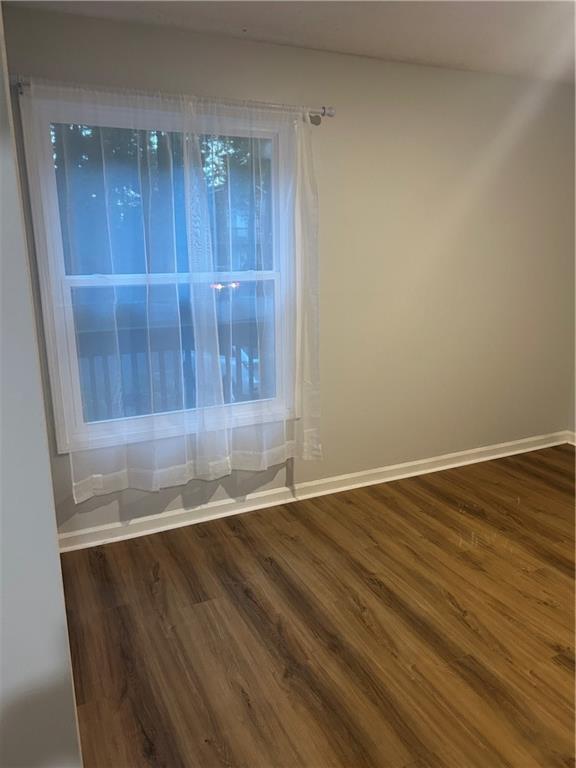 1230 Hanover Place Alpharetta, GA 30009 - Photo 11 of 29 an empty room with wooden floor and sliding door