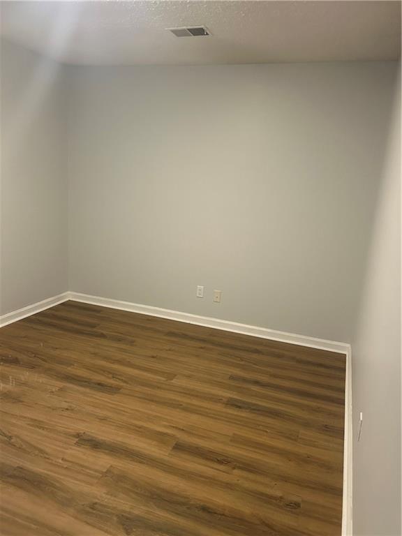 1230 Hanover Place Alpharetta, GA 30009 - Photo 12 of 29 a view of an empty room with wooden floor