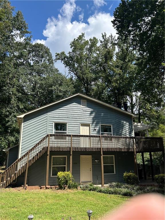 1230 Hanover Place Alpharetta, GA 30009 - Photo 4 of 29 a front view of a house with a garden and plants