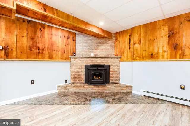 a view of a livingroom with a fireplace and window