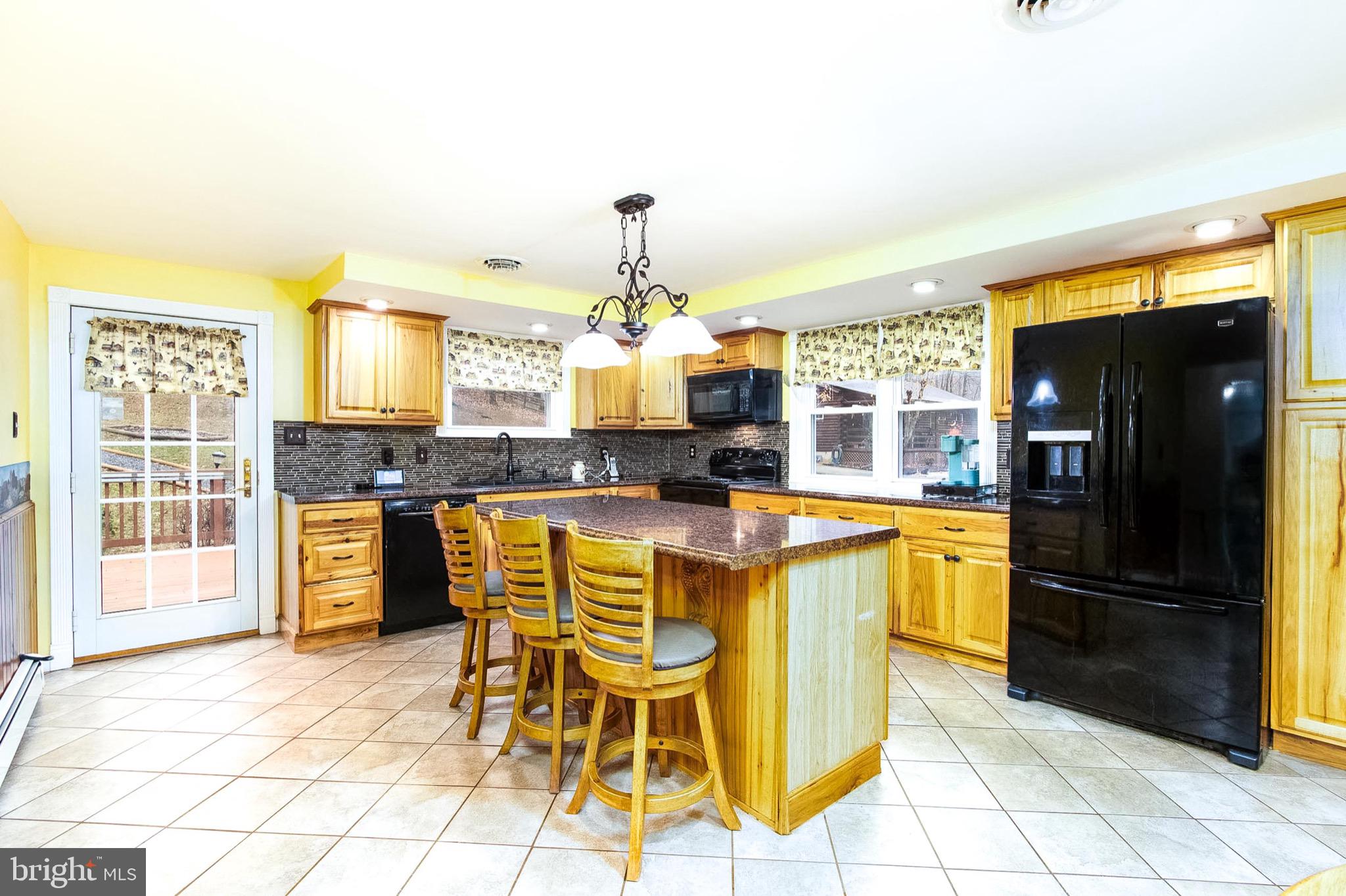355 Silver Run Valley Road Westminster, MD 21158 - Photo 2 of 49 a kitchen with granite countertop a refrigerator and a stove top oven