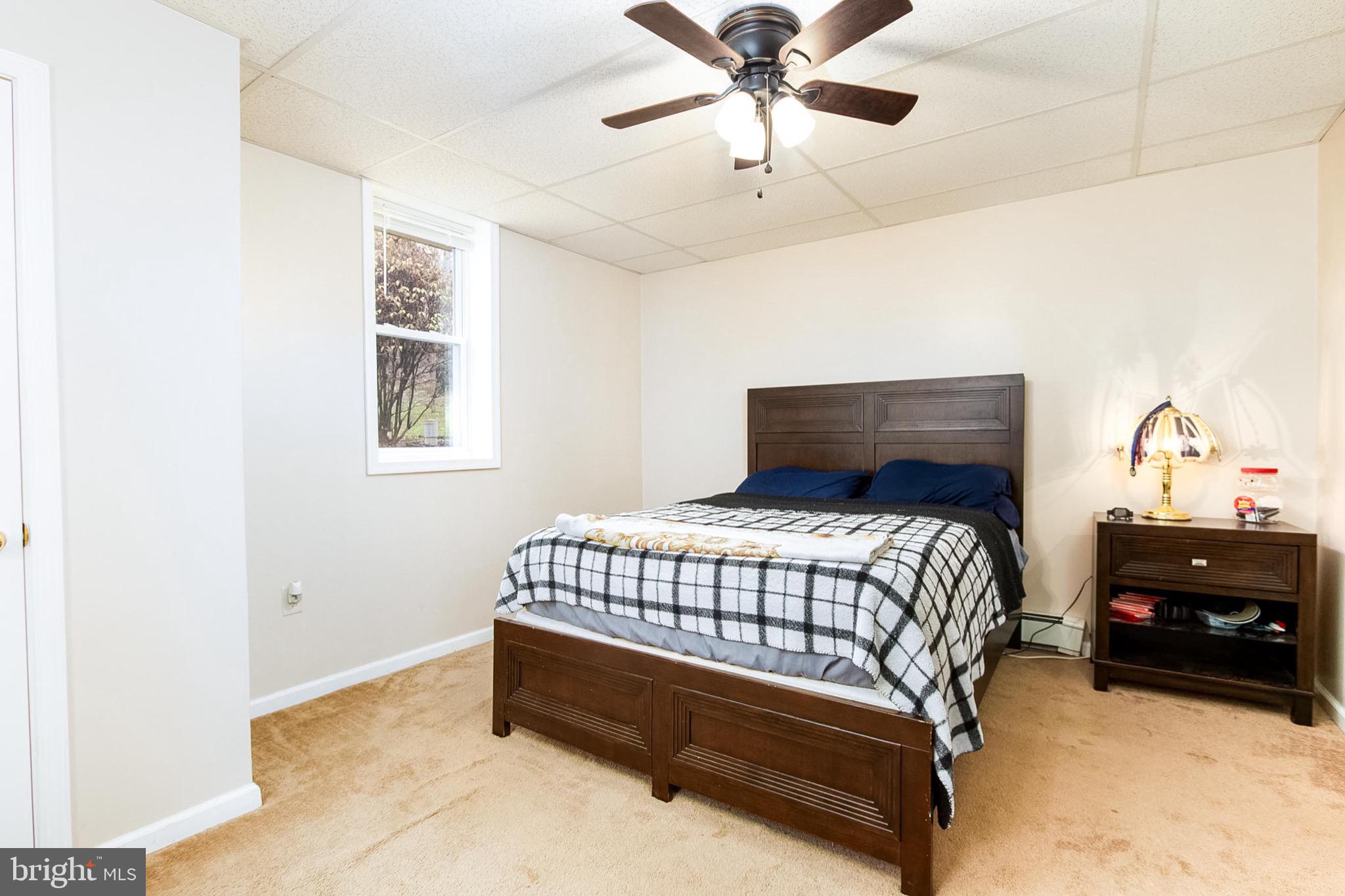 355 Silver Run Valley Road Westminster, MD 21158 - Photo 22 of 49 a bedroom with a bed and a chandelier