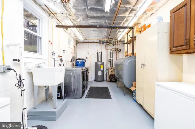 a view of a storage & utility room with refrigerator