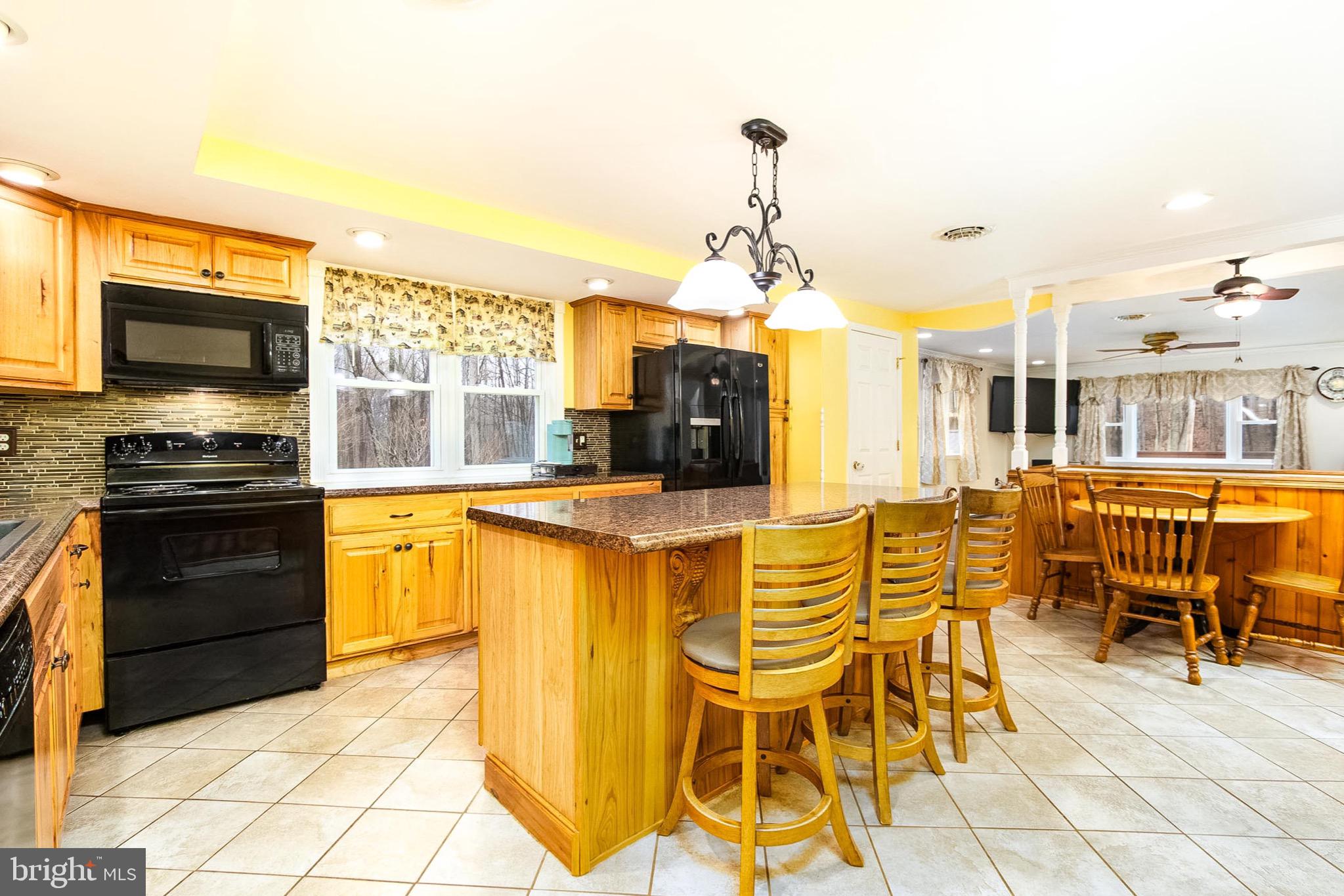 355 Silver Run Valley Road Westminster, MD 21158 - Photo 5 of 49 a kitchen with stainless steel appliances kitchen island granite countertop a stove and a sink