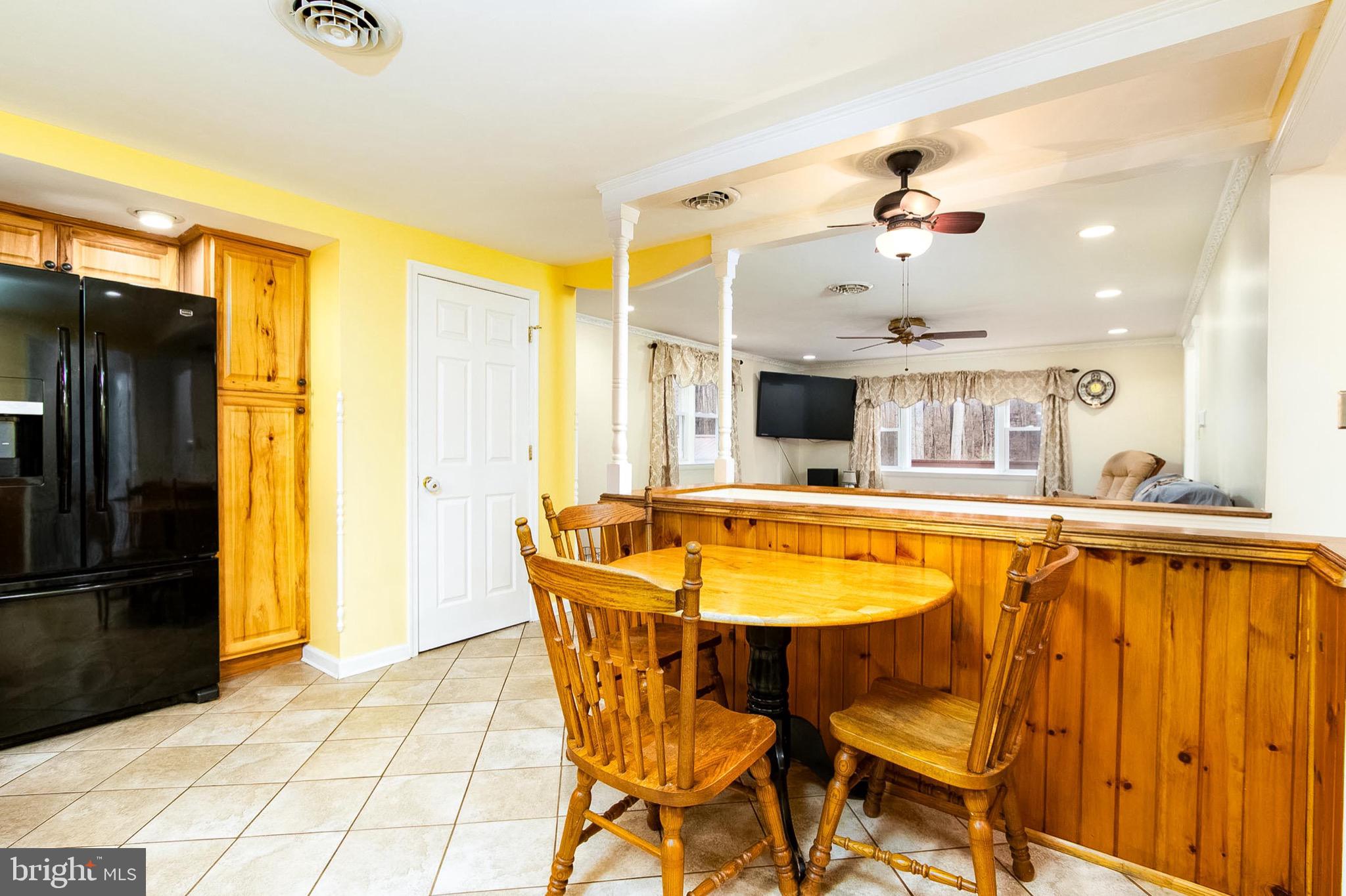 355 Silver Run Valley Road Westminster, MD 21158 - Photo 6 of 49 a dining room with stainless steel appliances kitchen island granite countertop a table and chairs