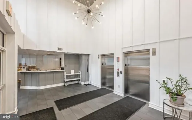 a living room with stainless steel appliances kitchen island granite countertop furniture and a kitchen view