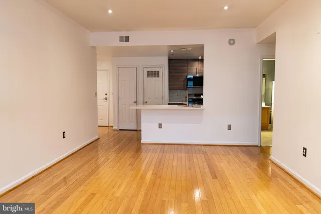 a view of a room with wooden floor and cabinet