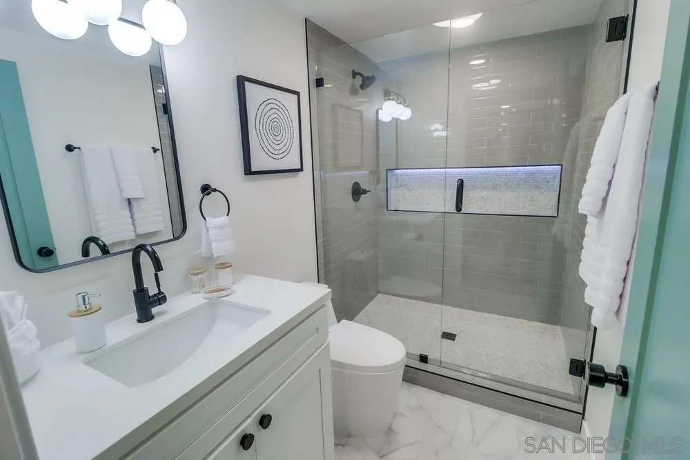 4584 3rd Street La Mesa, CA 91941 - Photo 13 of 57 a bathroom with a sink a toilet and shower