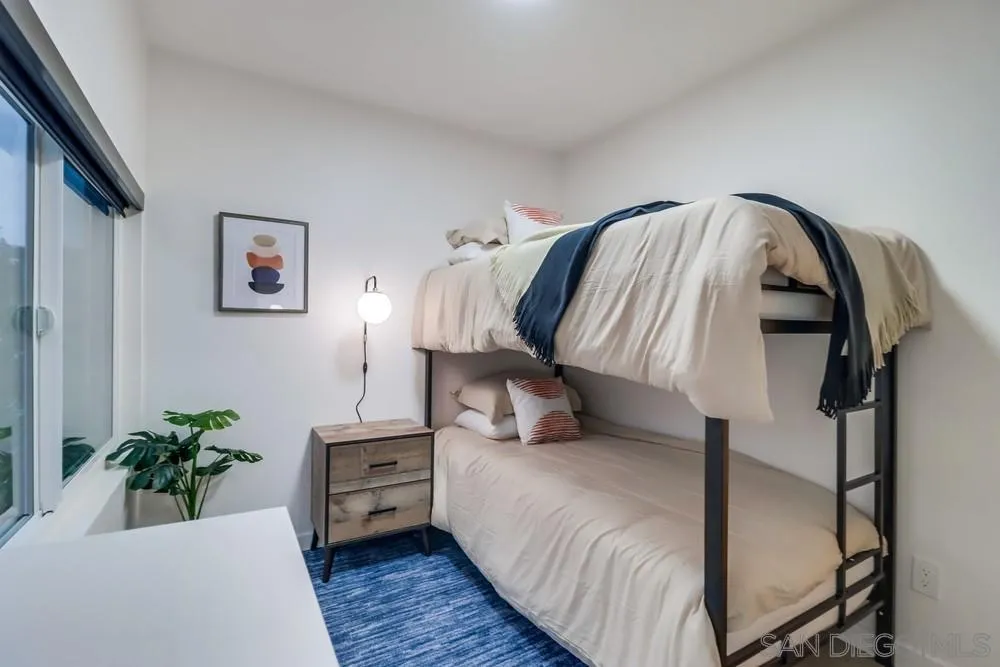 4584 3rd Street La Mesa, CA 91941 - Photo 17 of 57 a bed room with a bed and a painting on the wall