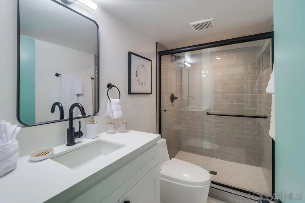 4584 3rd Street La Mesa, CA 91941 - Photo 18 of 57 a bathroom with a sink a toilet and shower