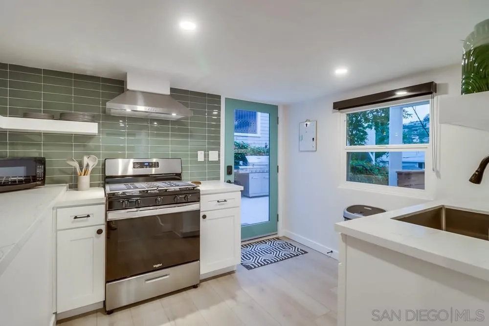4584 3rd Street La Mesa, CA 91941 - Photo 23 of 57 a kitchen with a stove and a sink