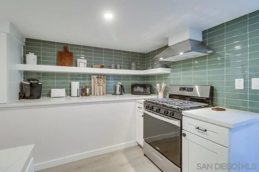 4584 3rd Street La Mesa, CA 91941 - Photo 24 of 57 a kitchen with a stove and cabinets
