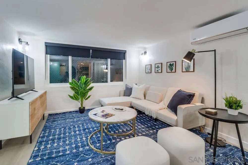 4584 3rd Street La Mesa, CA 91941 - Photo 25 of 57 a living room with furniture a flat screen tv and a rug