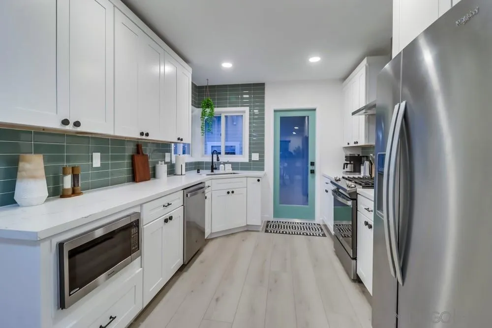 4584 3rd Street La Mesa, CA 91941 - Photo 8 of 57 a kitchen with a sink stainless steel appliances and cabinets