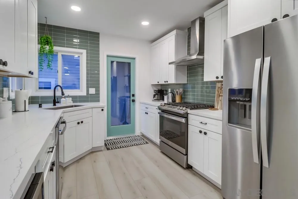 4584 3rd Street La Mesa, CA 91941 - Photo 9 of 57 a kitchen with stainless steel appliances a refrigerator sink and cabinets