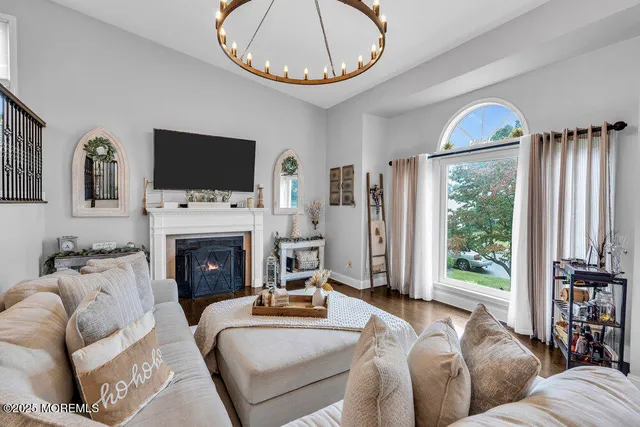 a living room with furniture a fireplace and a flat screen tv