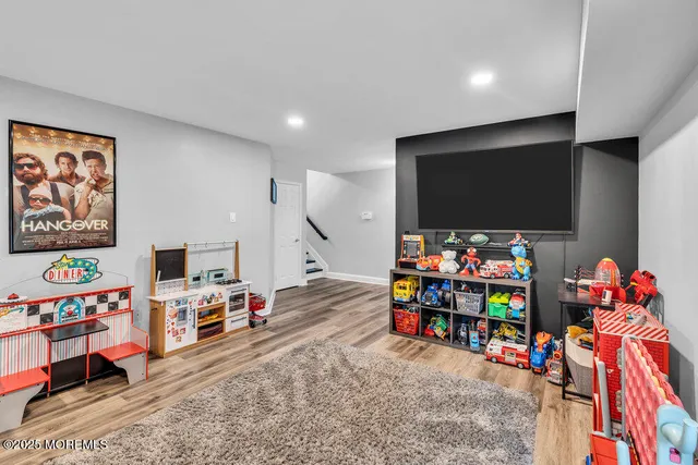 a playing room with toys and a flat screen tv