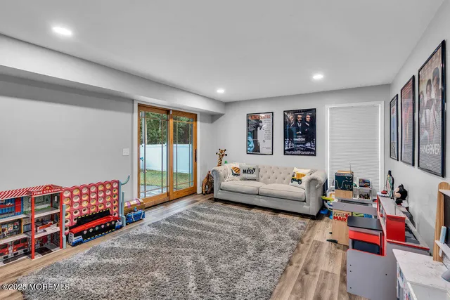 a living room with furniture a rug and a flat screen tv