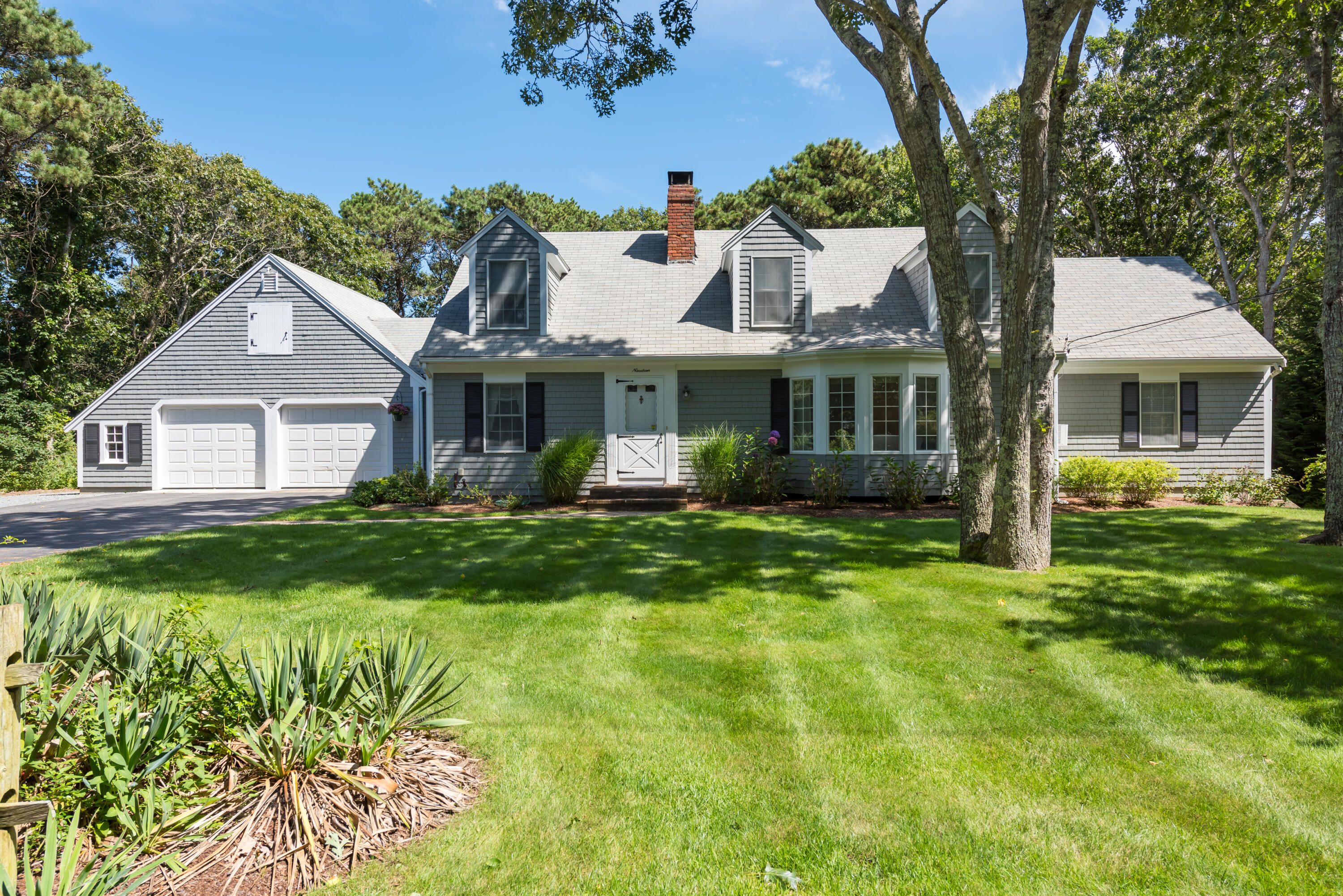 19 Monomoy Road Harwich Port, MA 02646 - Photo 1 of 28 a front view of a house with a garden