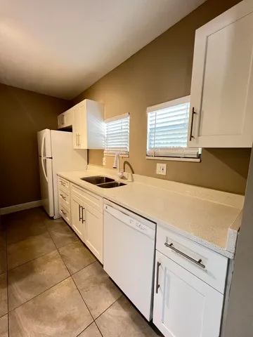 a kitchen with a cabinets and white appliances