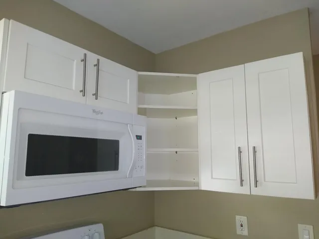 a kitchen with white cabinets and a fireplace