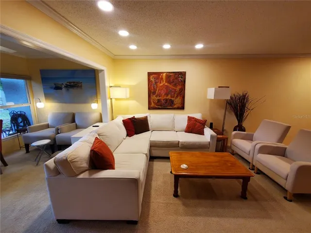 a living room with furniture and a lamp