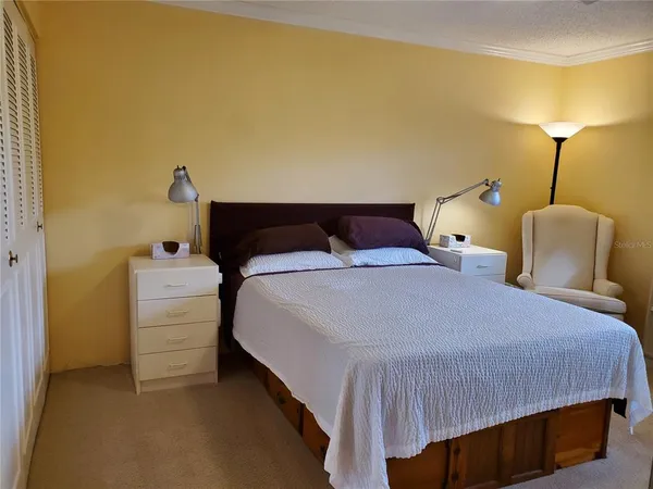 a bedroom with a bed and a closet