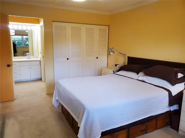 a bedroom with a bed and a cabinets