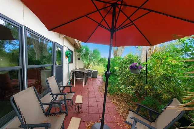a patio with a patio table and chairs