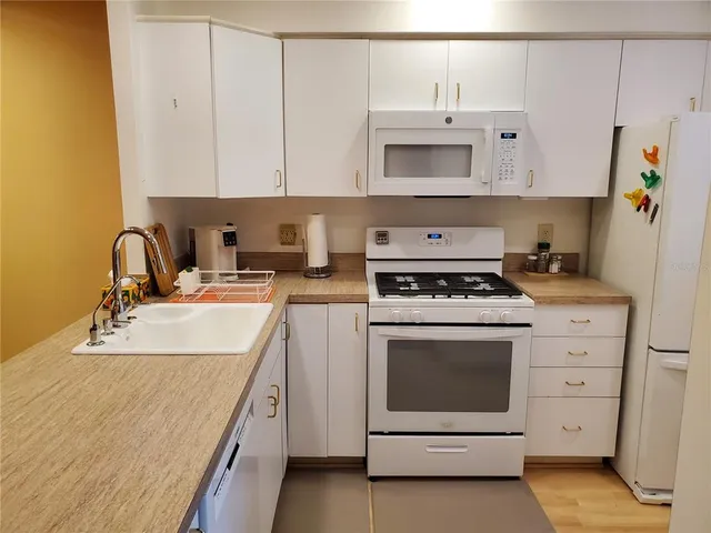 a kitchen with a sink stove and cabinets