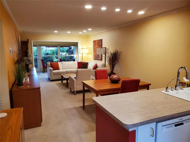 a living room with fireplace furniture and a large window