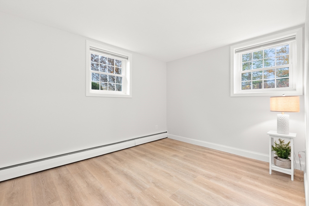 37 Holten Street, Unit 2 Danvers, MA 01923 - Photo 14 of 30 an empty room with wooden floor and windows