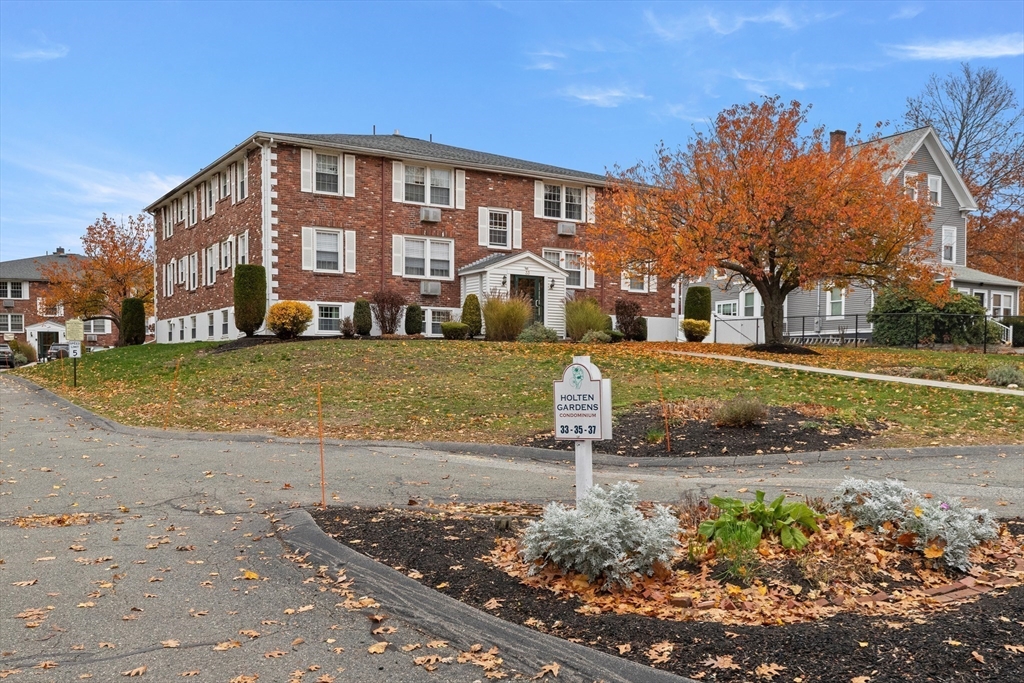37 Holten Street, Unit 2 Danvers, MA 01923 - Photo 28 of 30 a front view of a building with a yard
