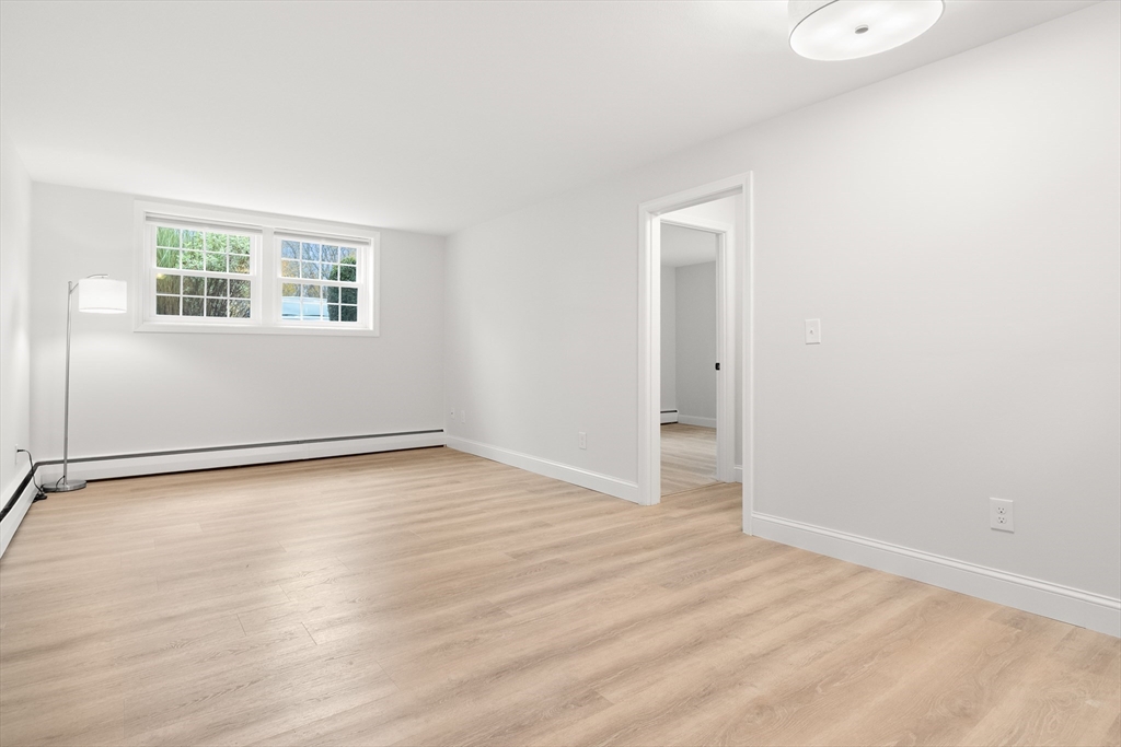 37 Holten Street, Unit 2 Danvers, MA 01923 - Photo 4 of 30 an empty room with wooden floor and windows