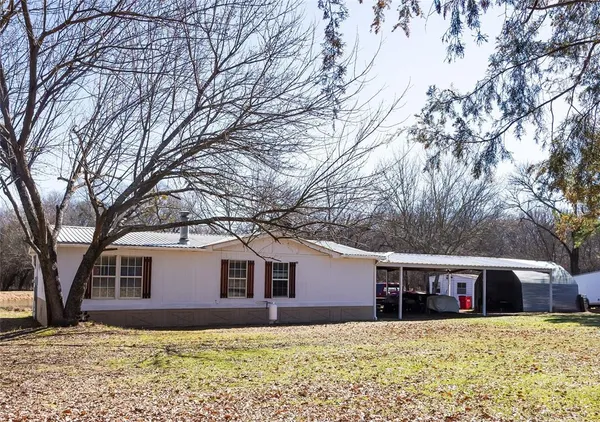 a house that has a tree in front of it