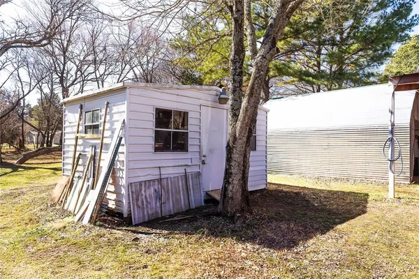 a view of a backyard with a large tree
