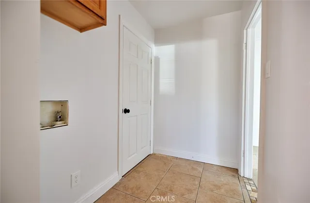 a view of a hallway with wooden floor and closet