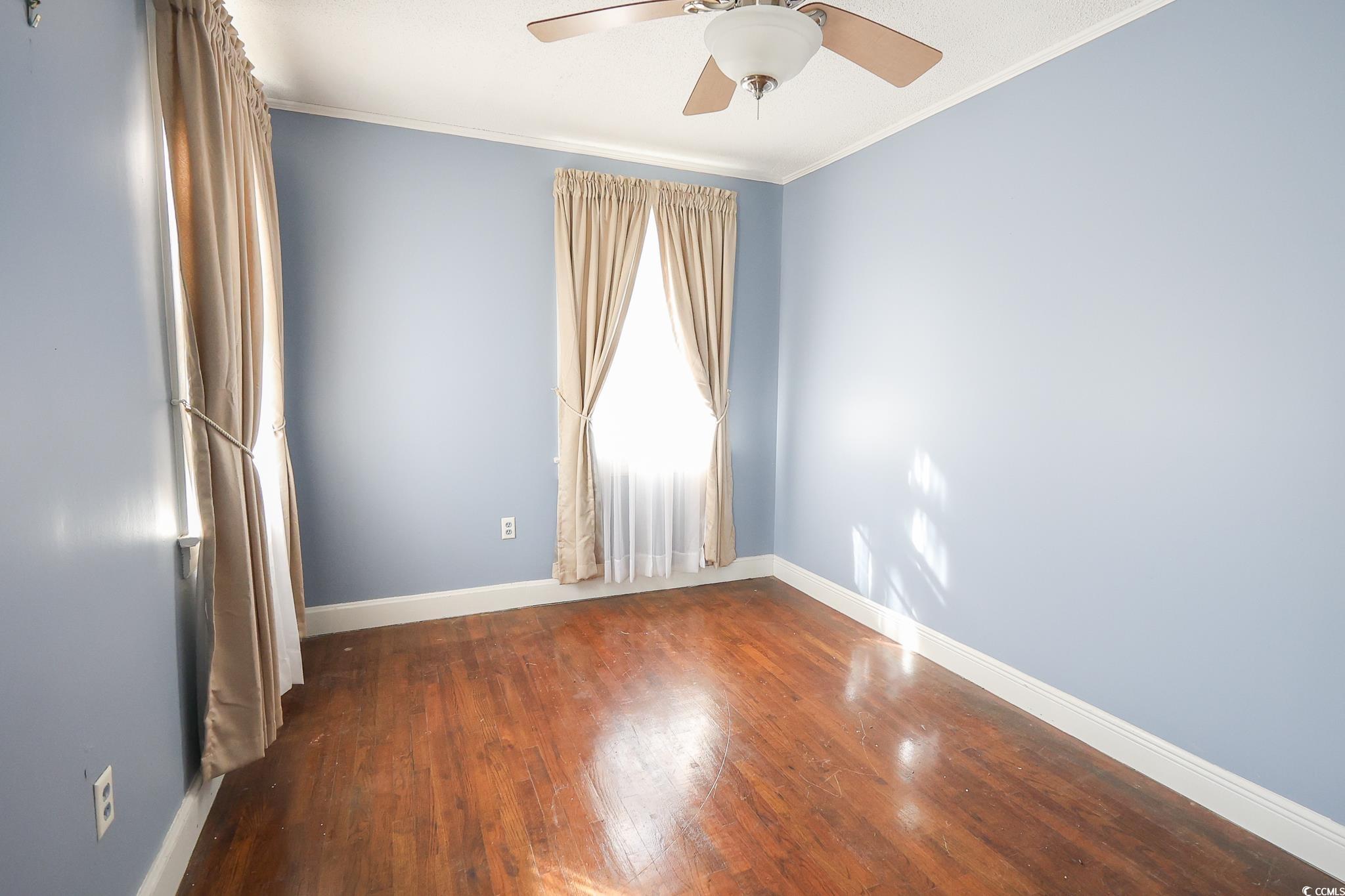 1841 Jasper Street Georgetown, SC 29440 - Photo 21 of 33 Spare room featuring crown molding, dark hardwood / wood-style floors, and ceiling fan