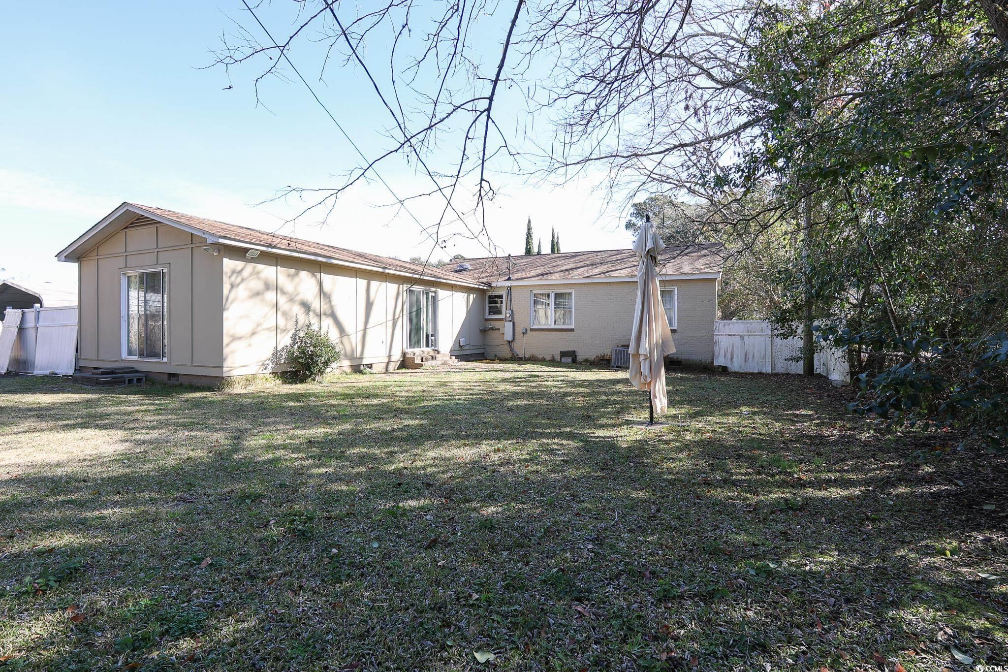 1841 Jasper Street Georgetown, SC 29440 - Photo 26 of 33 Rear view of house featuring a lawn