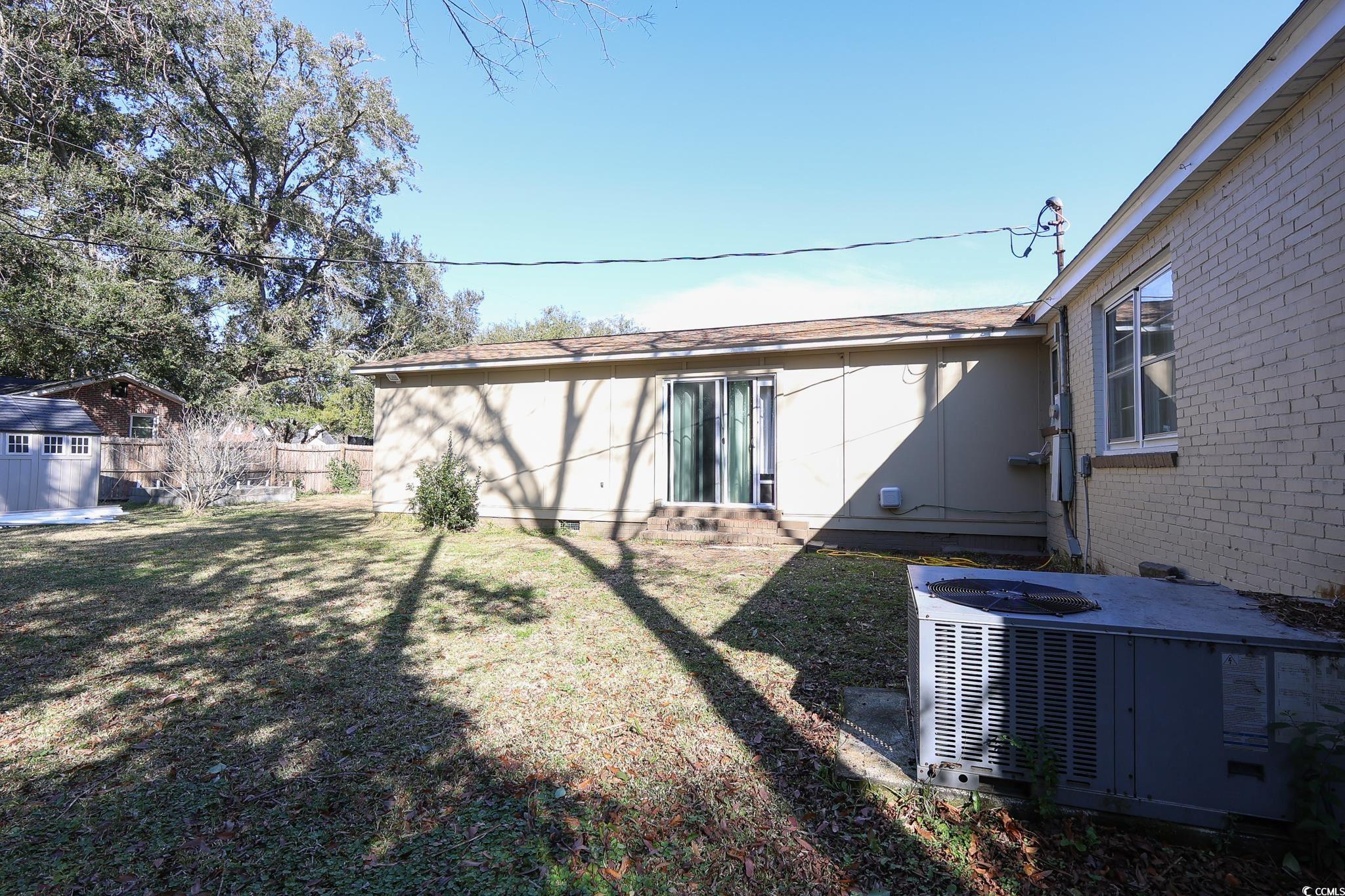 1841 Jasper Street Georgetown, SC 29440 - Photo 30 of 33 Back of property with cooling unit and a lawn