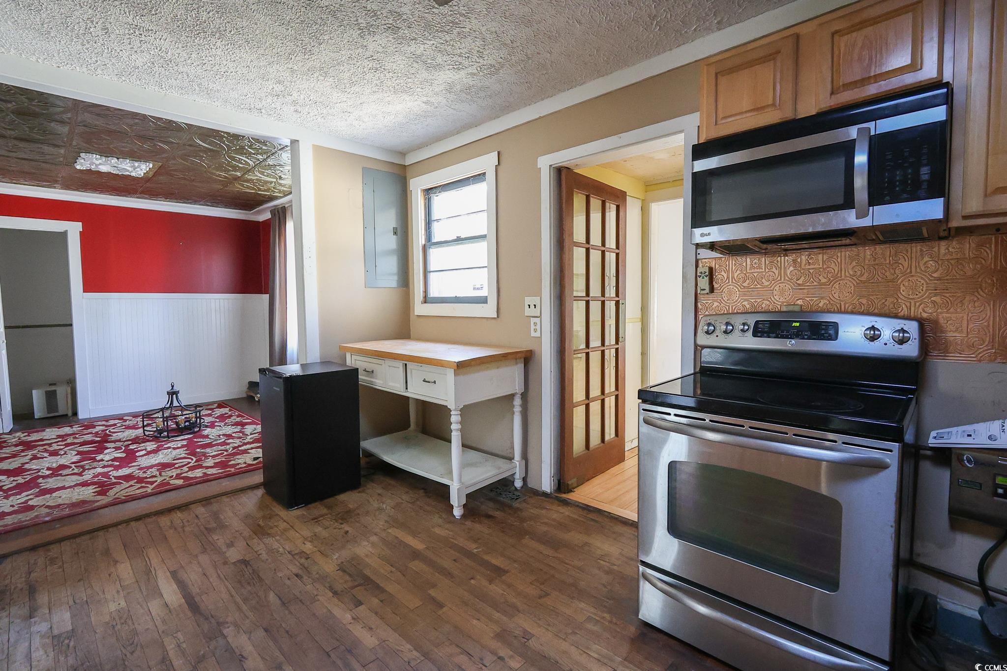 1841 Jasper Street Georgetown, SC 29440 - Photo 6 of 33 Kitchen featuring electric panel, dark hardwood / wood-style floors, a textured ceiling, and appliances with stainless steel finishes