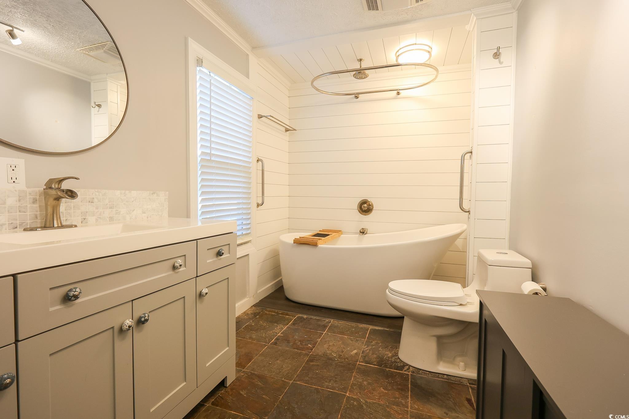 1841 Jasper Street Georgetown, SC 29440 - Photo 10 of 33 Bathroom with vanity, a bath, a textured ceiling, and toilet