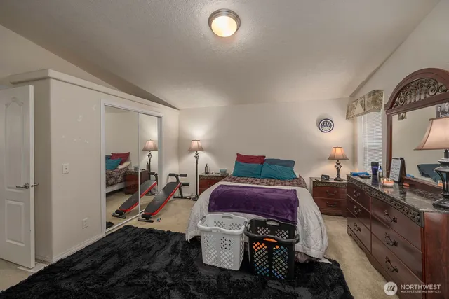 a bed room with a bed and a television