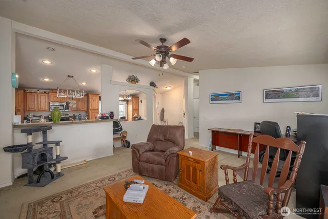 a living room with furniture and kitchen view