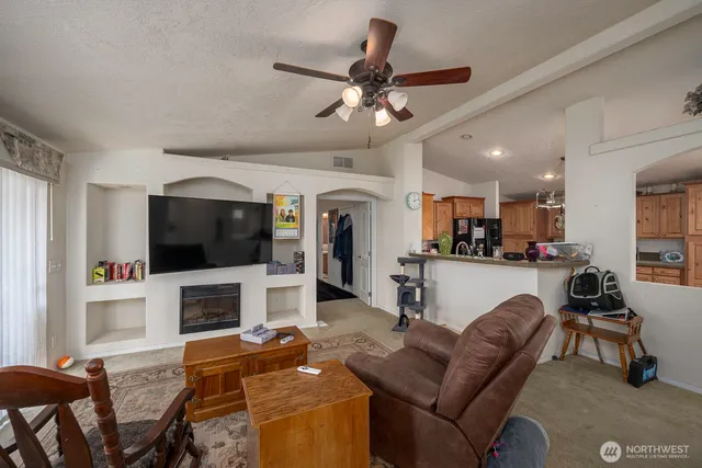 a living room with fireplace furniture and a flat screen tv