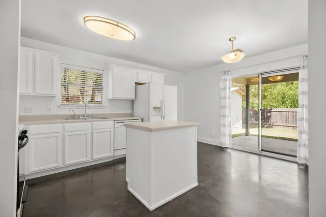 a kitchen with cabinets and a stove