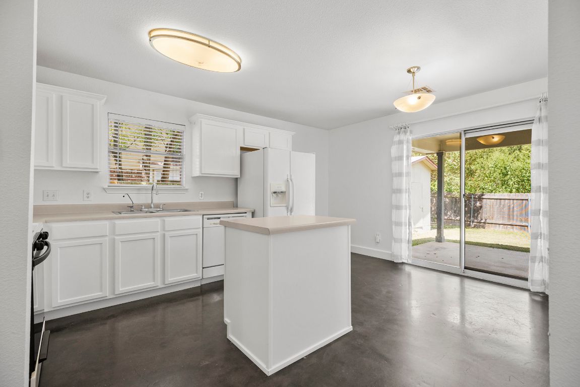 1886 Wallin Loop Round Rock, TX 78664 - Photo 12 of 28 a kitchen with a white cabinets and wooden floor