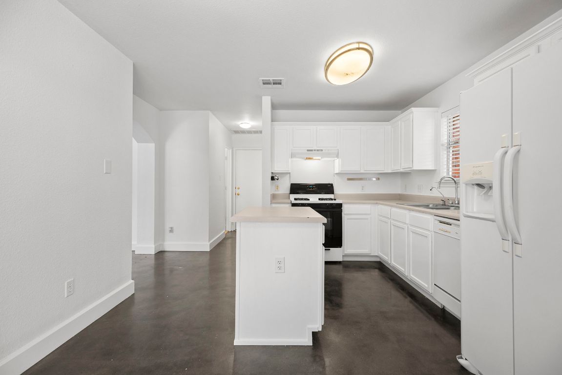 1886 Wallin Loop Round Rock, TX 78664 - Photo 13 of 28 a kitchen with cabinets and a stove