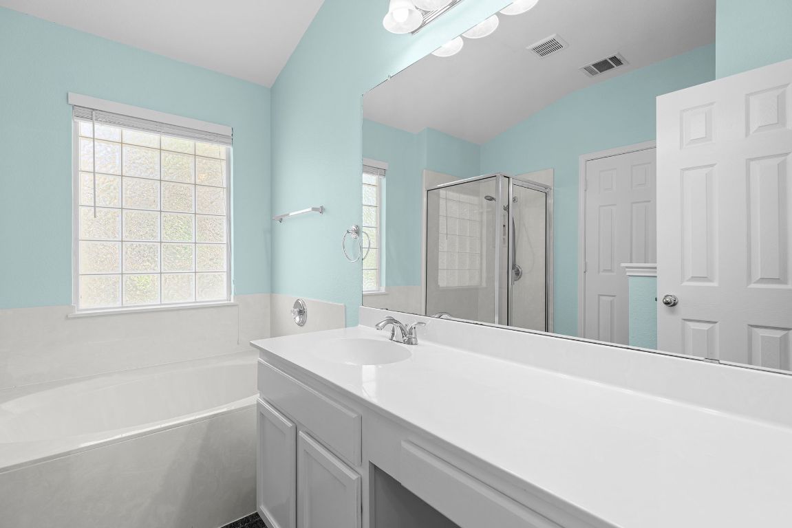 1886 Wallin Loop Round Rock, TX 78664 - Photo 23 of 28 a bathroom with a tub sink and mirror