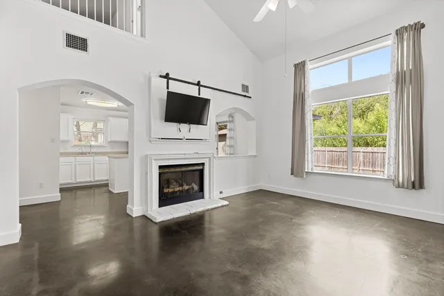 a view of a livingroom with furniture a fireplace and wooden floor